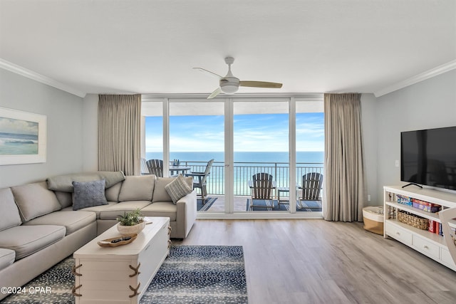 living room featuring crown molding, light hardwood / wood-style flooring, expansive windows, and ceiling fan