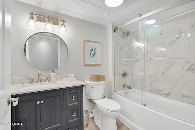 full bathroom featuring vanity, shower / bath combination with glass door, wood-type flooring, and toilet