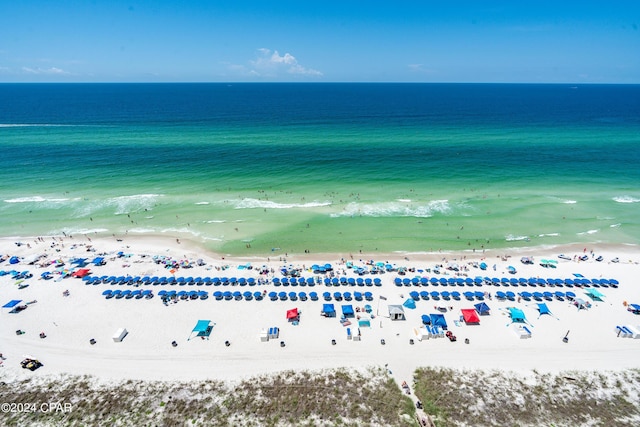 drone / aerial view featuring a water view and a view of the beach