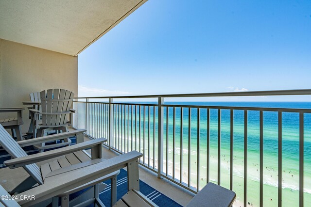 balcony featuring a water view and a view of the beach