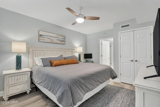 bedroom featuring a closet, ceiling fan, and wood-type flooring