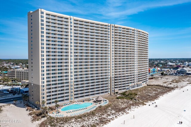 bird's eye view featuring a water view and a beach view