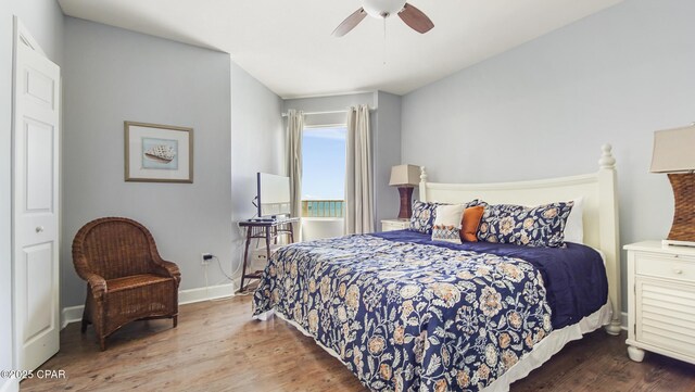 bedroom featuring hardwood / wood-style flooring, a closet, and ceiling fan