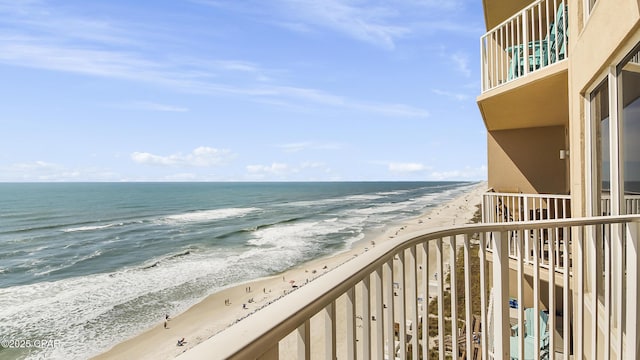 exterior space featuring a water view and a beach view