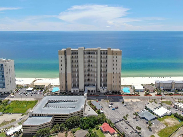 birds eye view of property with a water view and a beach view