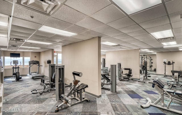 exercise room with a drop ceiling and carpet floors