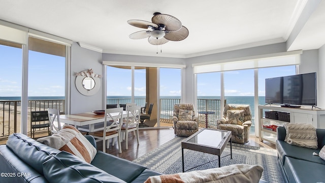 living room with ceiling fan, ornamental molding, and hardwood / wood-style floors