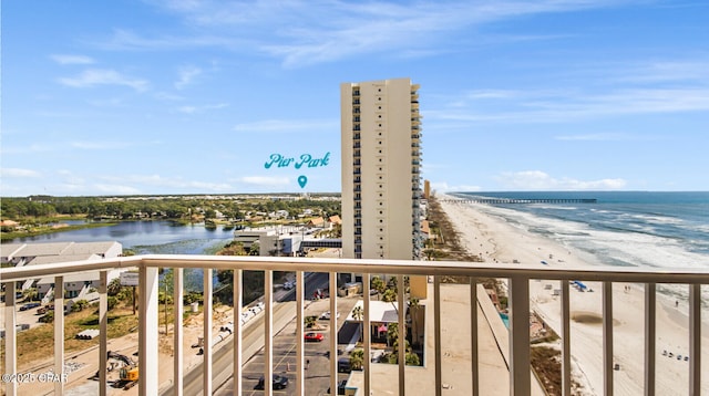 balcony with a water view and a beach view