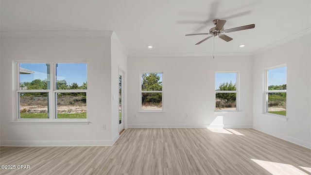 unfurnished living room with baseboards, ornamental molding, a wealth of natural light, and wood finished floors