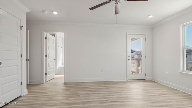 empty room with light wood-style floors, plenty of natural light, and ornamental molding