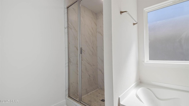 full bath with a garden tub and a marble finish shower