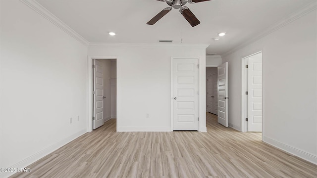 unfurnished bedroom with ornamental molding, light wood-type flooring, visible vents, and baseboards