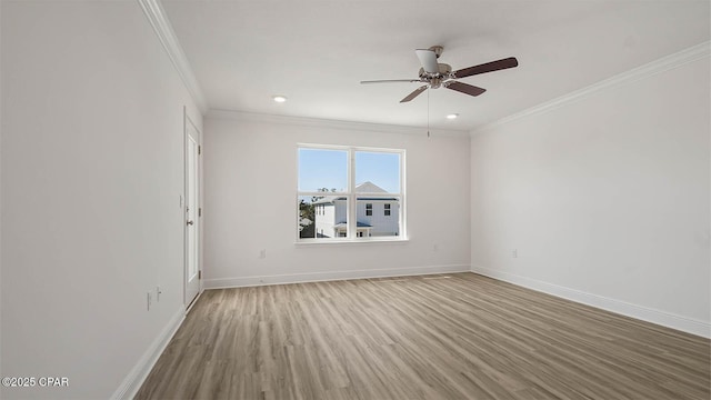 unfurnished room with ceiling fan, baseboards, wood finished floors, and ornamental molding