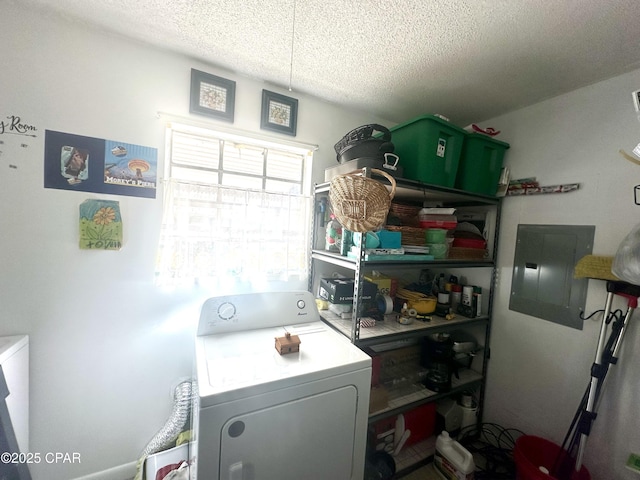 clothes washing area with washer / clothes dryer, electric panel, and a textured ceiling