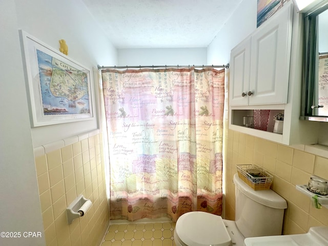 bathroom with toilet, a textured ceiling, tile walls, and shower / bath combo