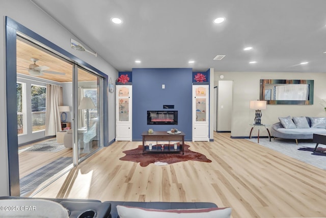 living room featuring light hardwood / wood-style floors and ceiling fan