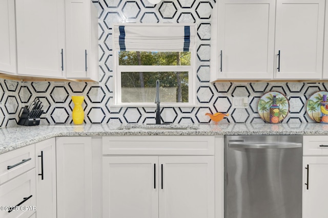 kitchen featuring white cabinets and dishwasher