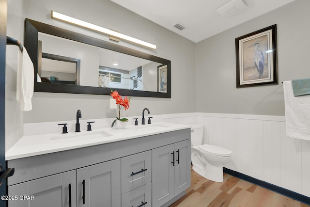 bathroom featuring vanity, hardwood / wood-style flooring, a shower with curtain, and toilet