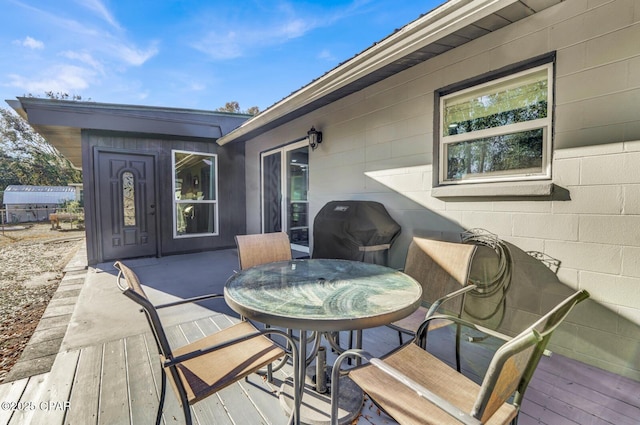 wooden terrace featuring area for grilling