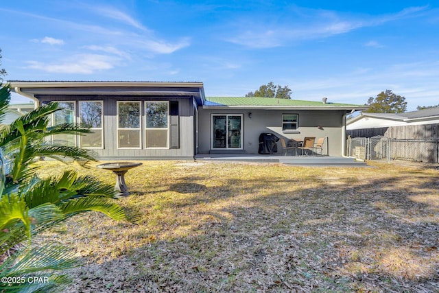 rear view of house featuring a yard and a patio area