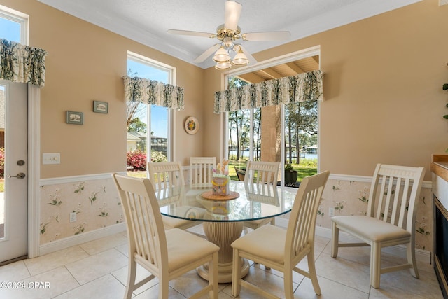 dining area featuring plenty of natural light, light tile patterned floors, and crown molding