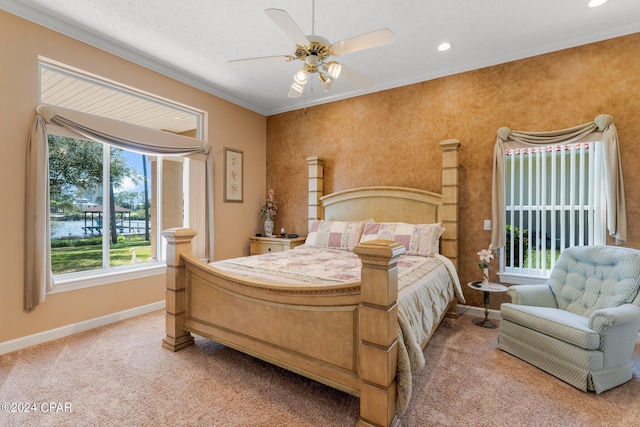 bedroom with carpet floors, ceiling fan, and ornamental molding