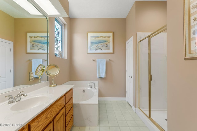 bathroom with vanity, a skylight, and shower with separate bathtub