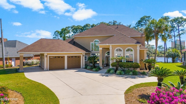 mediterranean / spanish-style house featuring a front yard and a garage