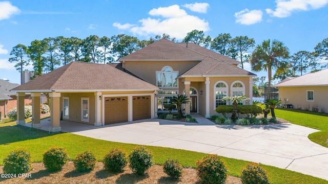 mediterranean / spanish-style house with a garage and a front yard