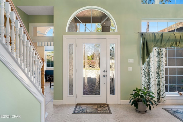 tiled foyer featuring a towering ceiling