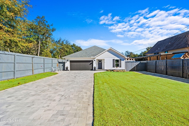 view of front of house with a garage and a front lawn