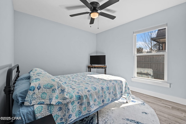 bedroom with hardwood / wood-style flooring and ceiling fan