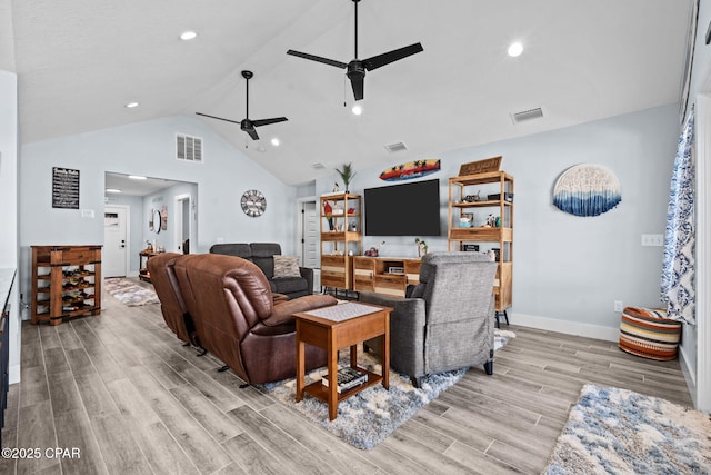 living room featuring ceiling fan, high vaulted ceiling, and light hardwood / wood-style floors