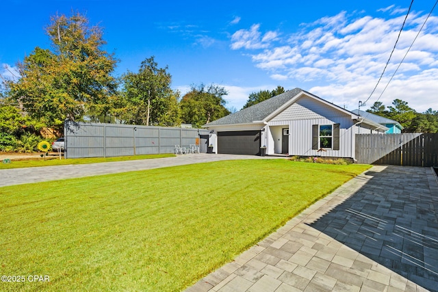 view of front of house featuring a garage and a front lawn