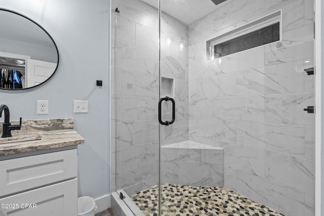 bathroom with vanity and a shower with shower door