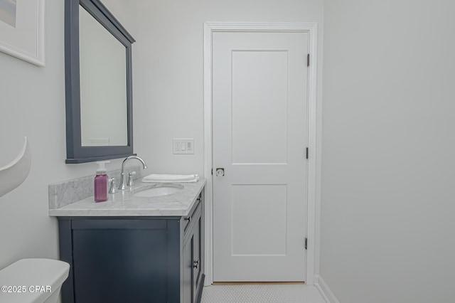 bathroom featuring tile patterned floors, vanity, and toilet