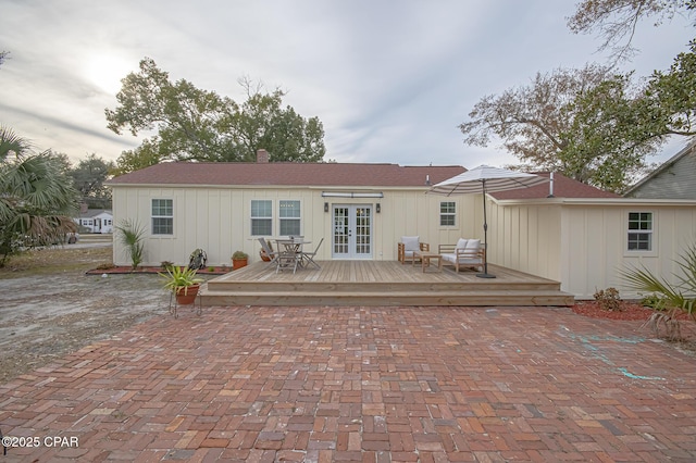 back of house with french doors and a deck