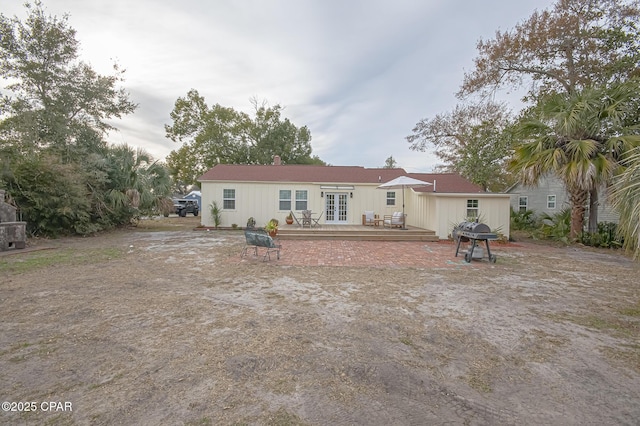 rear view of house featuring french doors and a deck