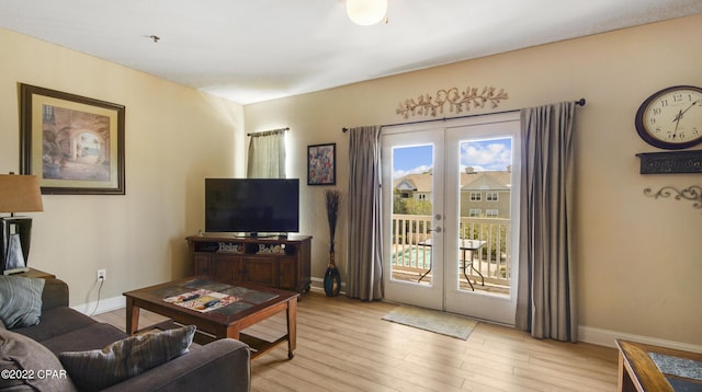 living room with french doors and light wood-type flooring