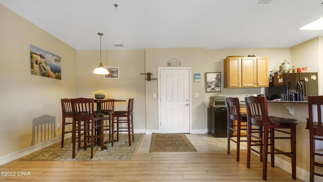 dining area featuring light wood-type flooring