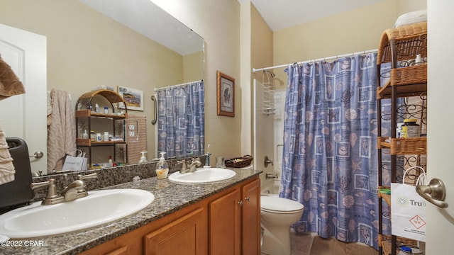 full bathroom featuring shower / bathtub combination with curtain, vanity, and toilet