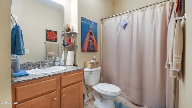 bathroom featuring tile patterned floors, vanity, and toilet