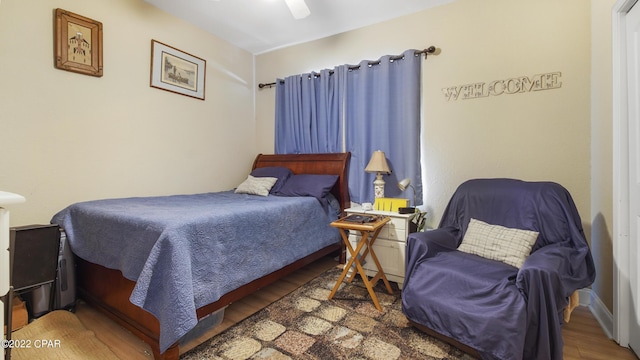 bedroom with wood-type flooring and ceiling fan