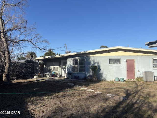 rear view of property featuring central AC unit