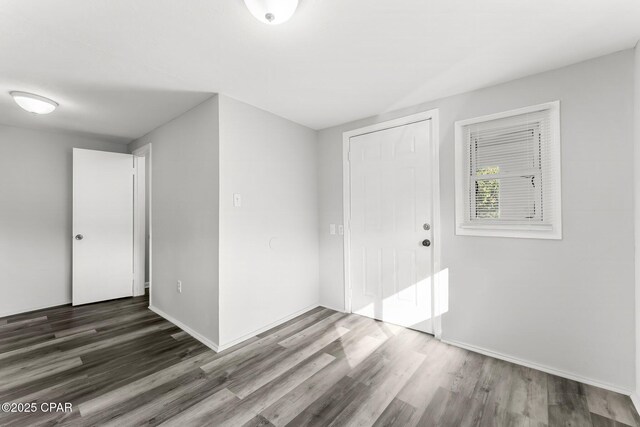 1905 W 17th St, Panama City, FL 32405 - empty room with wood finished floors and baseboards