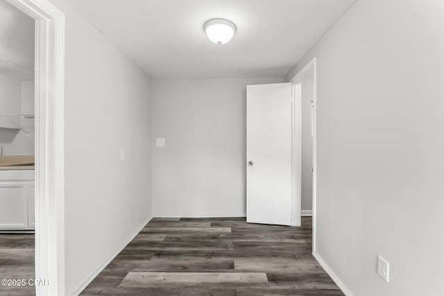 hallway with dark wood-type flooring