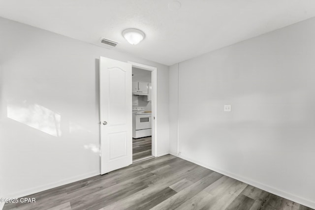 1905 W 17th St, Panama City, FL 32405 - unfurnished room with wood finished floors, baseboards, and visible vents
