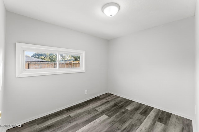 unfurnished room with dark hardwood / wood-style floors