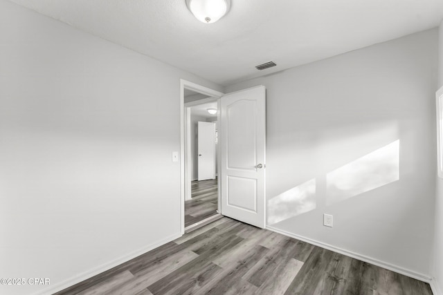 spare room featuring hardwood / wood-style floors