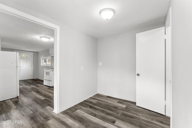 empty room featuring dark hardwood / wood-style flooring and a textured ceiling